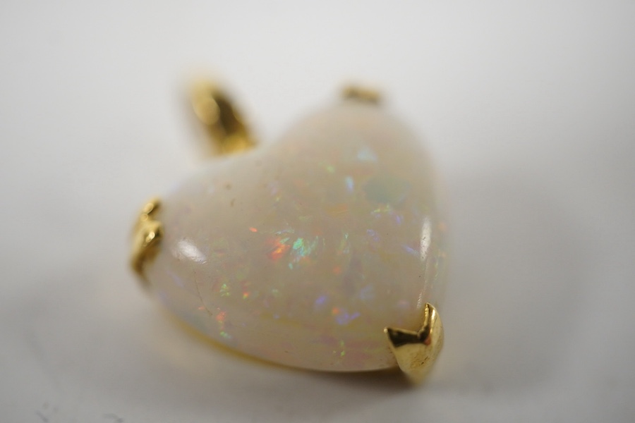 A modern 18ct gold mounted heart shaped white opal pendant, overall 20mm, gross weight 3.2 grams. Condition - fair to good